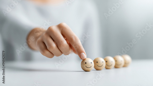 Smiling face wooden ball hand happiness emotion positive row close up human choice selection concept cheerful motivation success optimistic