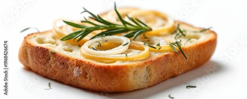 Slice of focaccia bread topped with onion rings and fresh rosemary sprigs on a white studio background. Golden crust, fluffy interior, rustic Italian food.