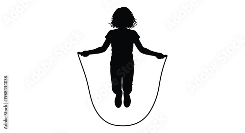 A young girl joyfully jumps rope depicted in a striking silhouette