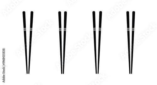 Four pairs of black chopsticks arranged neatly a striking silhouette
