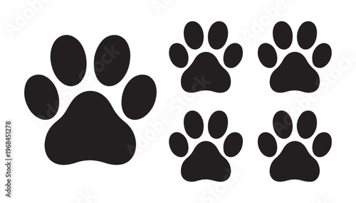 Large and small dog paw prints in black solid silhouette style, isolated on white background.