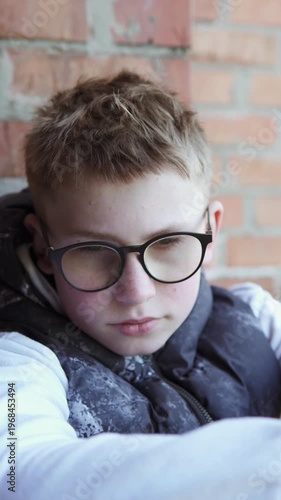 A teenage boy sits alone on an abandoned construction site after school, looking sad and pensive. The atmosphere conveys themes of bullying, loneliness, and emotional struggle in an urban environment.