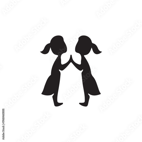 Two girls in silhouette holding hands in a friendly gesture