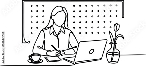 Woman sitting at desk with laptop computer and coffee cup working on paperwork and using pen on notepad