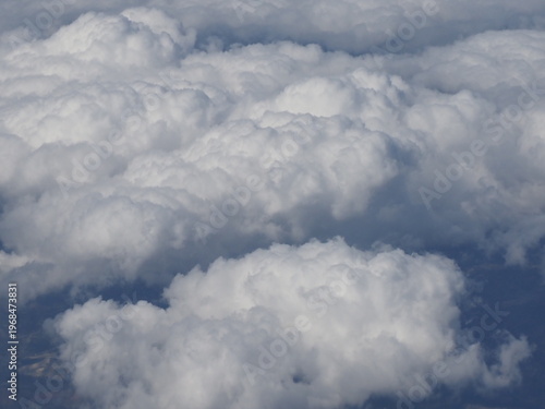Close up view of thick white cumulus clouds texture during flight above weather