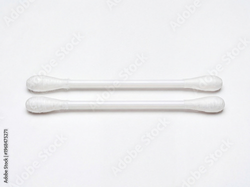 Two white plastic cotton swabs with cotton tips on a plain white surface for hygiene and cleaning purposes transparent background