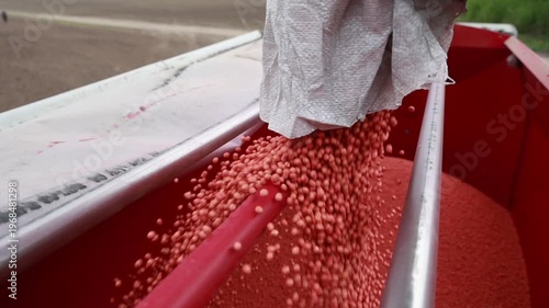 Slow Motion Pouring Sugar Beet Seeds into Seeder Hopper