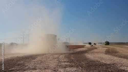 Slow Motion Combine Harvester Harvesting Soybeans in Agricultural Field