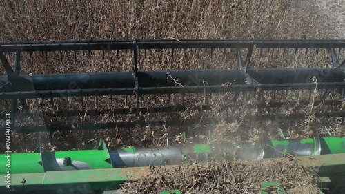 Slow Motion Combine Harvester Harvesting Soybeans in Agricultural Field