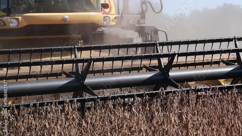 Slow Motion Combine Harvester Harvesting Soybeans in Agricultural Field