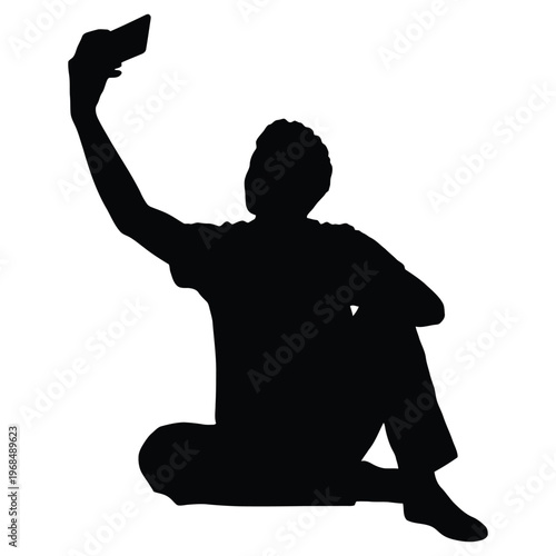 A person is seated and taking a self portrait with their mobile phone silhouette