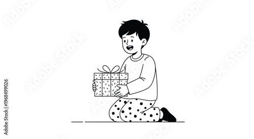 Happy young boy in polka dot pajamas kneels on the floor while happily holding a large patterned Christmas gift box.