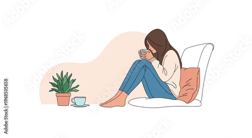 Young woman sitting on a cushion and relaxing while holding a warm mug of tea or coffee in a cozy indoor setting with a plant.