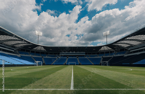 Vászonkép A vast stadium with empty seats under a partly cloudy sky during daytime