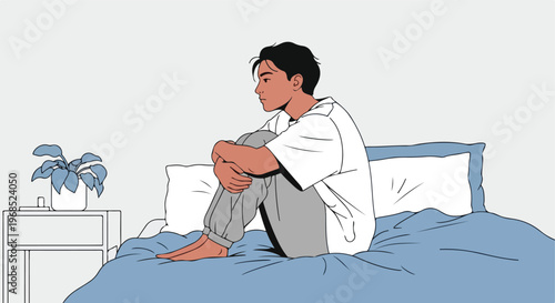 A young man sits alone on a bed with a pensive and melancholic expression on face