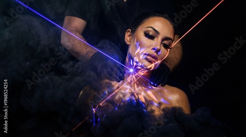 Beautician performing laser skin treatment on woman. Professional aesthetic cosmetology procedure with glowing light beams and smoke. Innovative skincare technology for facial rejuvenation.