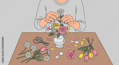 A person arranging a colorful bouquet of flowers into a small white ceramic vase