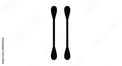 Two black spoons stand vertically on a white background