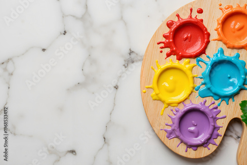 Colorful paint palette with vibrant acrylic colors and splashes for International Children's Day  