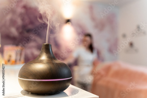Essential oil diffuser emitting mist for aromatherapy relaxation