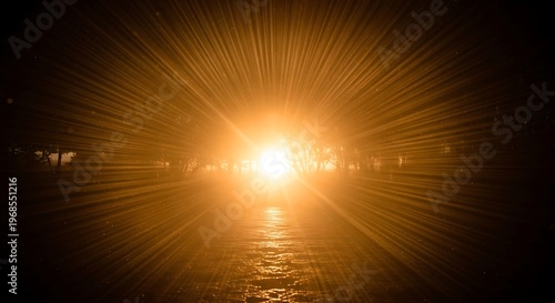 Bright sunburst illuminating a dark road at night with radiant light rays