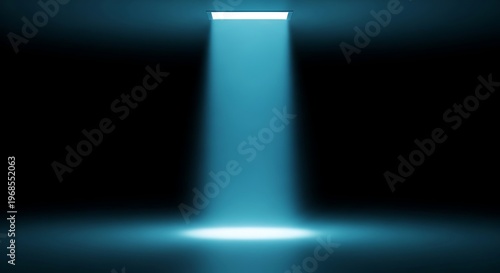 A single beam of blue light illuminates a dark space, creating a spotlight effect on a reflective surface.