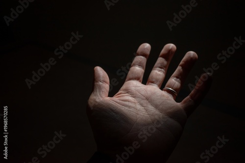 Open Hand Against Dark Background