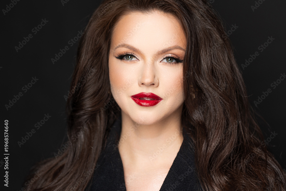 Fototapeta premium Luxurious young woman red lipstick, dark tonal portrait