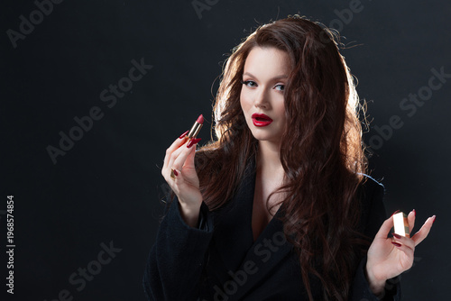 Glamorous brunette with red lipstick, dark background