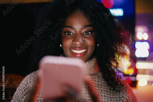 Tableau sur toile Serious woman in headphones using smartphone for remote task on street, focused female freelancer browsing application, 5G mobile network, wireless technology, digital nomad, startup culture