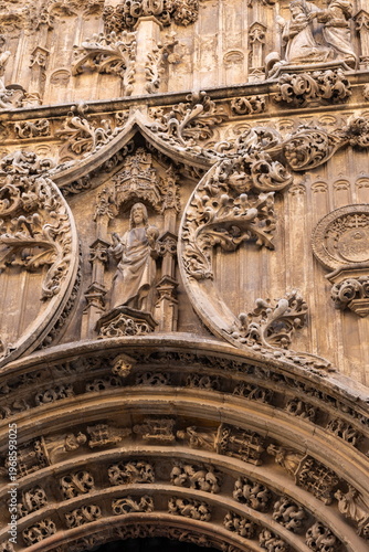 Intricate stone carvings adorn the facade of a historic building in Malaga, Spain, reflecting rich cultural heritage and artistic craftsmanship