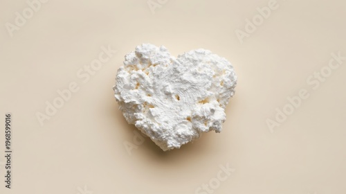 White Skincare Cream Shaped as Heart on Beige Background