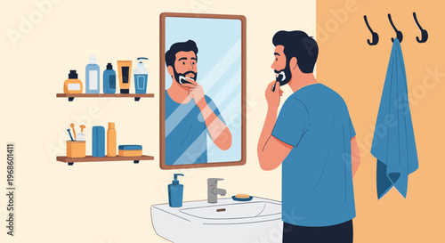 Young man looking at his reflection in a bathroom mirror while shaving his face with a razor and shaving cream.