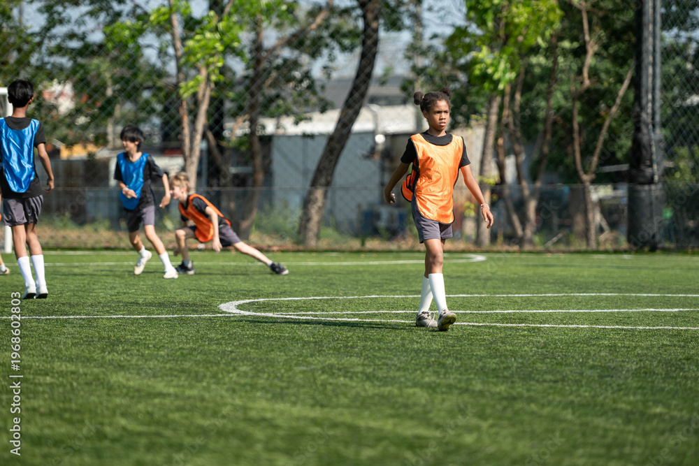 Obraz premium Group of international school kids playing soccer together