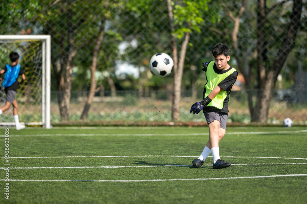 Obraz premium International school student practicing soccer dribbling