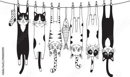 Cats and a fish hanging on a clothesline to dry