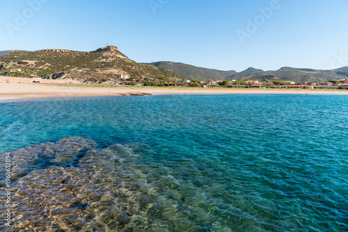 Wallpaper Mural The coast of Bosa Marina, a charming seaside village located in Sardinia, Italy. Scenic Mediterranean coastline with sandy beach, colorful buildings, and clear blue sea. Torontodigital.ca