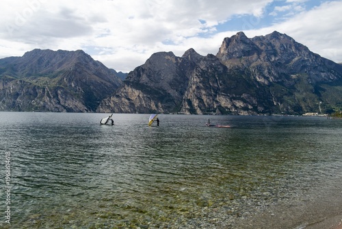 Windsurfers on Lake Garda with dramatic limestone cliffs