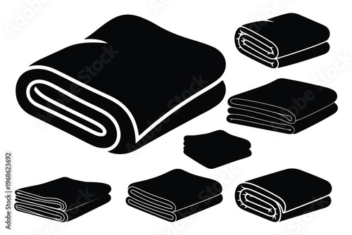 Black towels in various folded shapes and sizes rolled