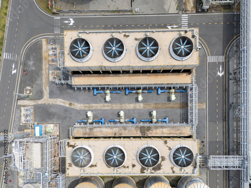 Large industrial plant with many fans and a lot of pipes. The fans are blue and the pipes are grey