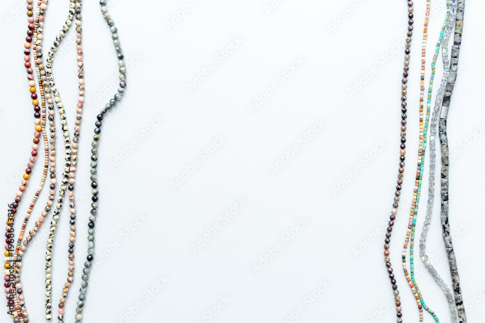 Naklejka premium Beads and necklaces of many gemstones and pearls, top view. Jewelry concept.