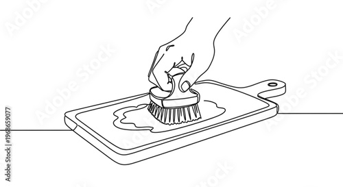 Hand scrubbing a wooden cutting board with a brush  