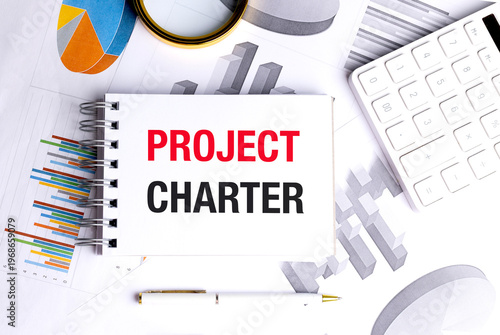 Project charter concept with business charts notebook and office tools planning strategy and project