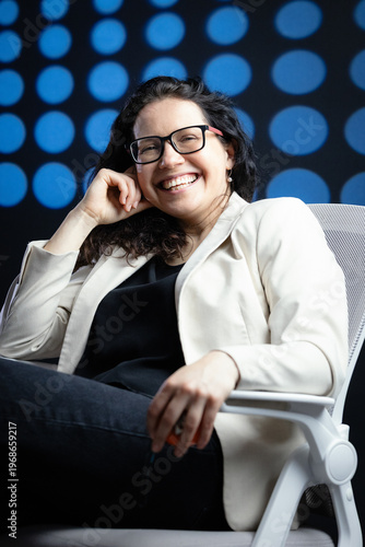 Professional woman wearing glasses smiling in office setting