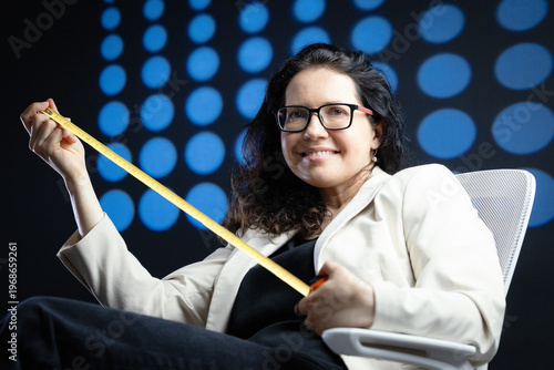 Woman holding measuring tape representing business measurement and analysis