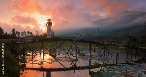Wide Shot Woman Standing on Wooden Bridge at Sunrise Lotus Pond