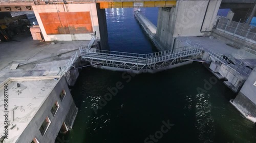 Aerial view of the Esna Lock gates on the Nile River in Luxor, Egypt, during the evening, showing industrial water management infrastructure.