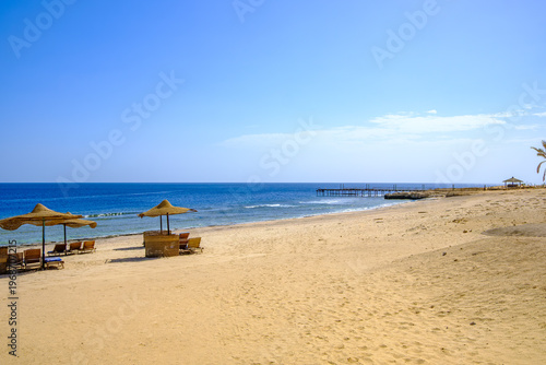 beach with umbrellas and chairs