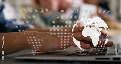 Typing adult hands wearing long-sleeve shirt pressing laptop keys at office, world map overlay