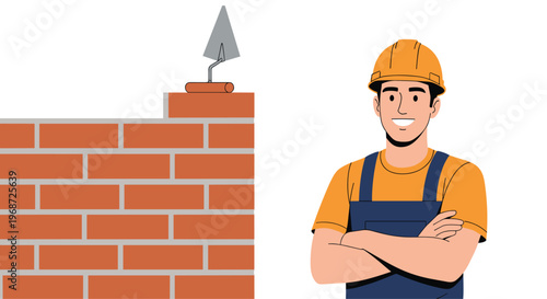 Smiling male construction worker wearing a hard hat and overalls standing next to a partially built brick wall with a trowel resting on top.